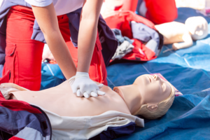 A nurse administering emergency CPR to a mannequin as part of CPR certification in Florida