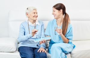 South Florida nursing schools' nurse assisting an elderly woman in her medication.